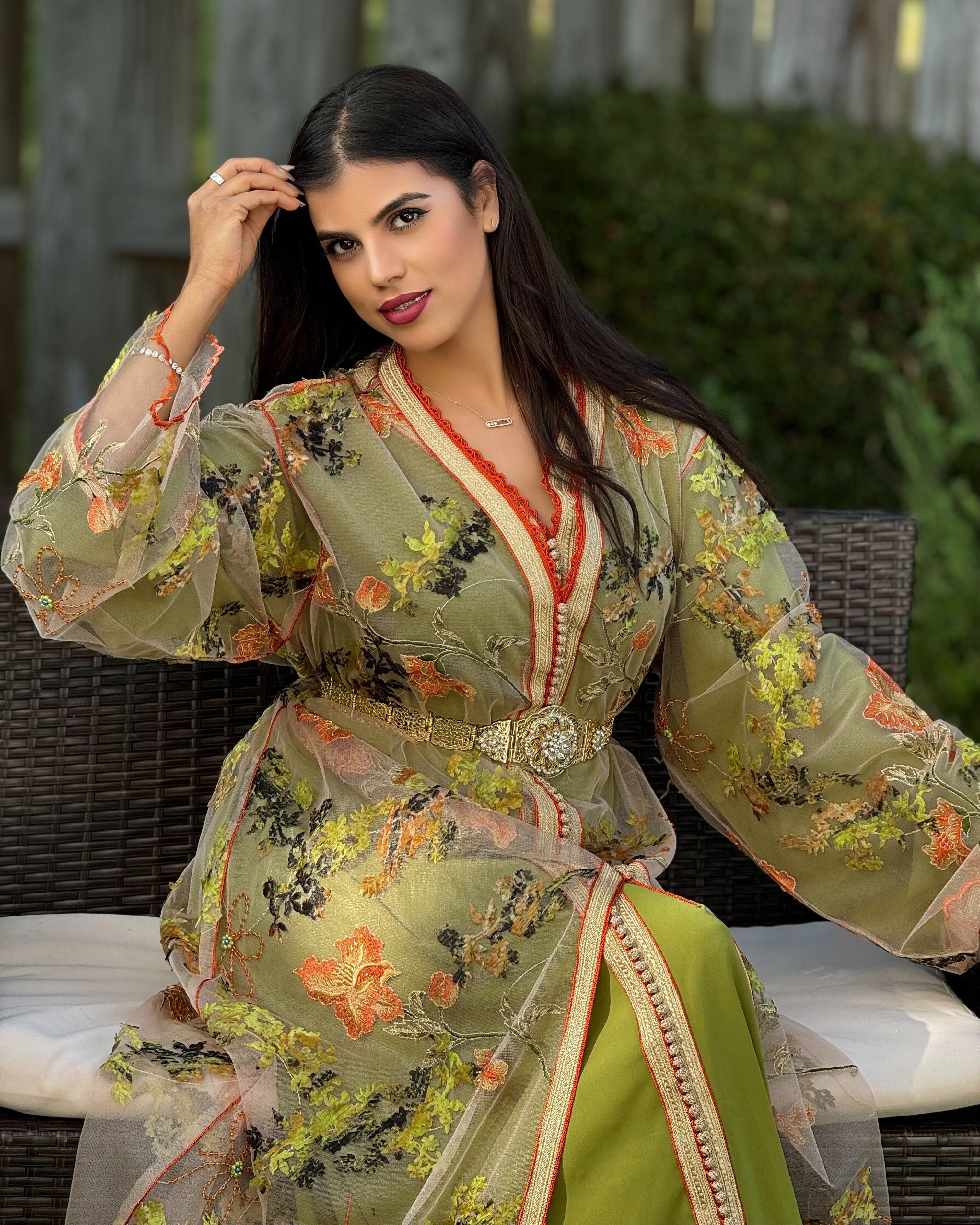 Woman wearing a floral dress sitting outdoors